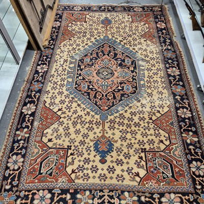 Lot 496 - An unusual antique Persian heriz small carpet...