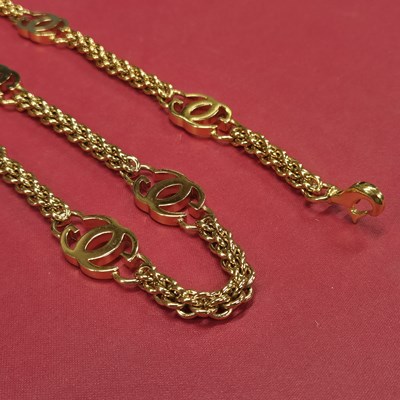 Lot 141a - Gucci- a vintage gold-plated logo chain belt.