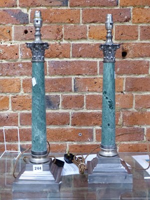Lot 244 - A pair of silver plate and marble column table...