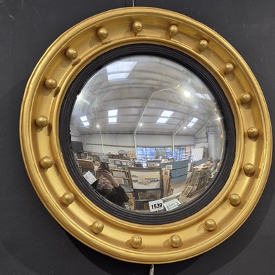 Lot 1539 - A large 19th-century convex wall mirror. 60 x...