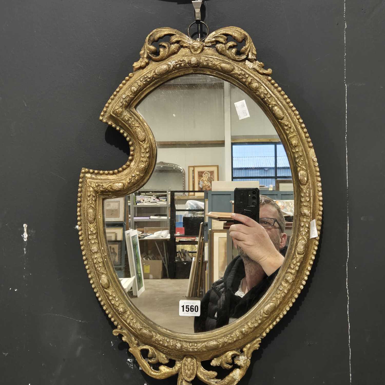 Lot 1560 - An antique gilt framed mirror.