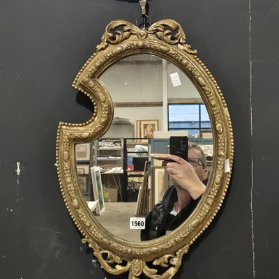 Lot 1560 - An antique gilt framed mirror.