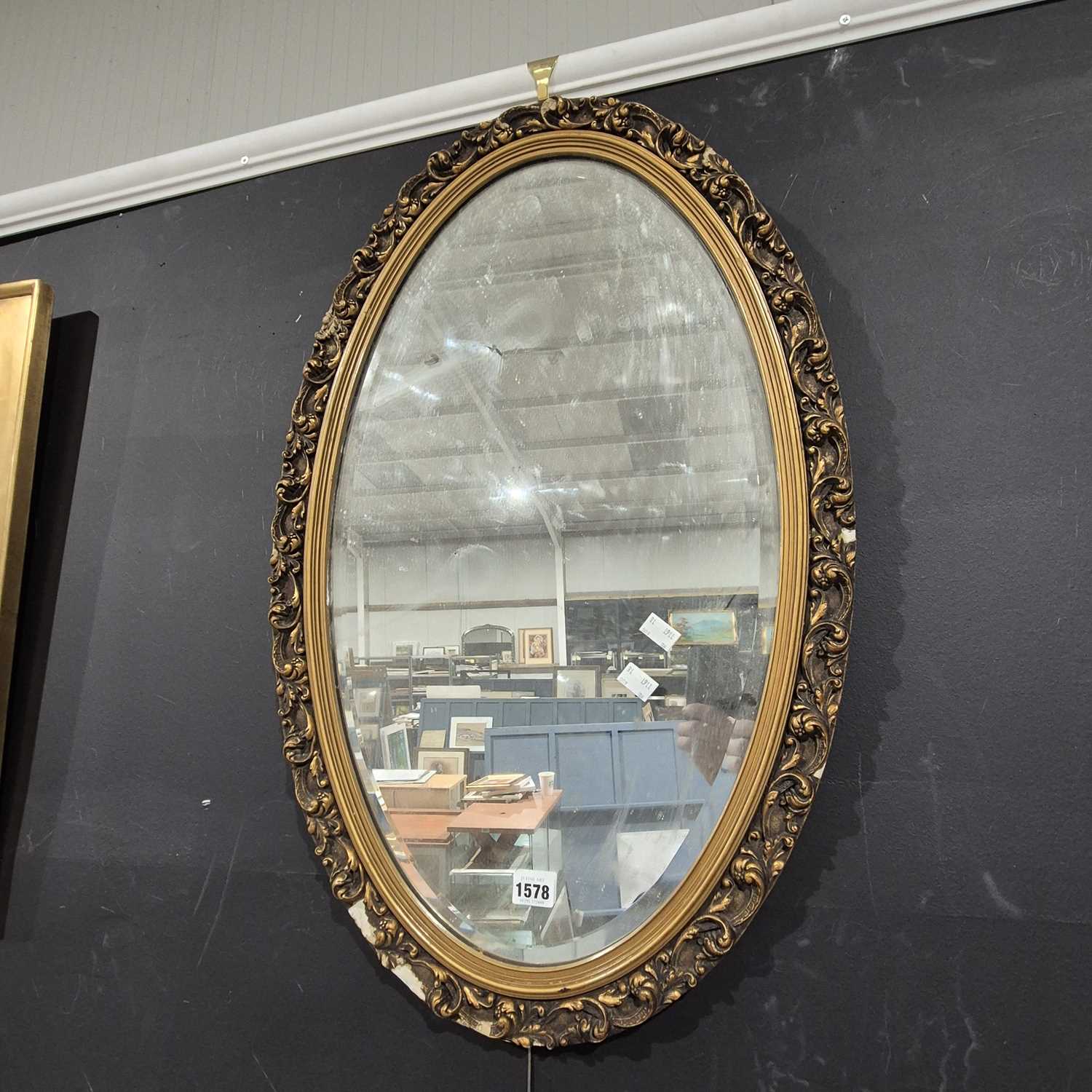 Lot 1578 - An oval gilt framed mirror.