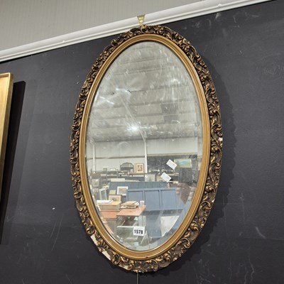 Lot 1578 - An oval gilt framed mirror.