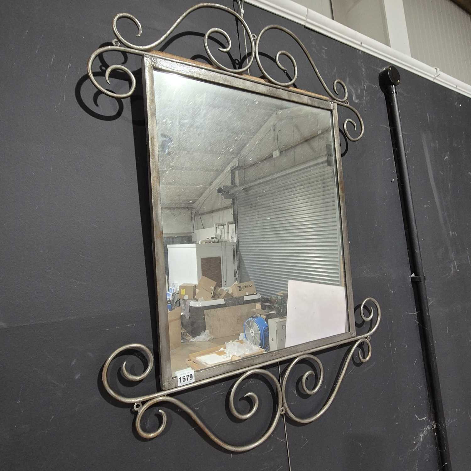 Lot 1579 - A wrought iron framed mirror.
