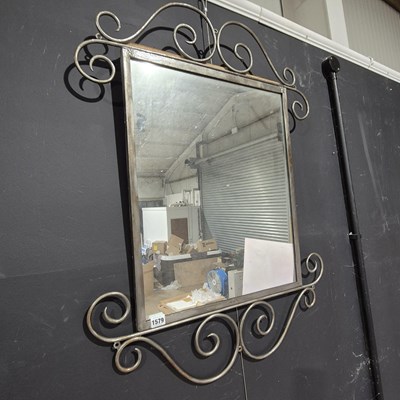Lot 1579 - A wrought iron framed mirror.