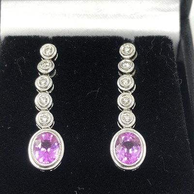 Lot 1010 - A pair of 18ct white gold drop earrings set...