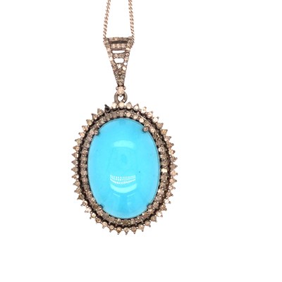 Lot 1015 - An oval pendant in white metal set with a...