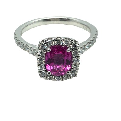 Lot 1023 - A platinum ring set with an oval pink sapphire...