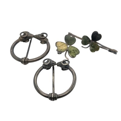 Lot 1025 - Two small shamrock brooches, each with three...