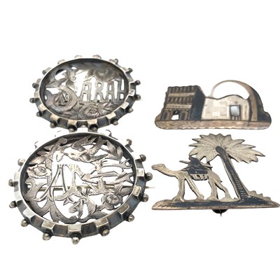 Lot 1084 - A group of four antique silver brooches,...
