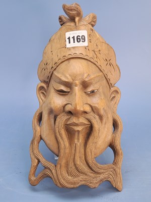 Lot 1169 - A Chinese carved wood wall mask of a bearded...