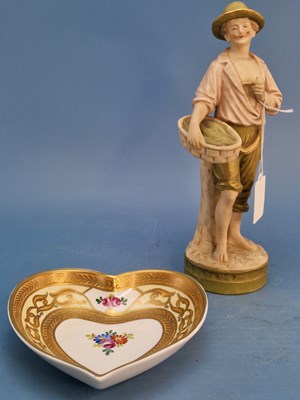 Lot 1199 - A Royal Dux figure of a fisherman standing...