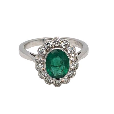 Lot 1039 - 18ct white gold ring with an oval emerald and...