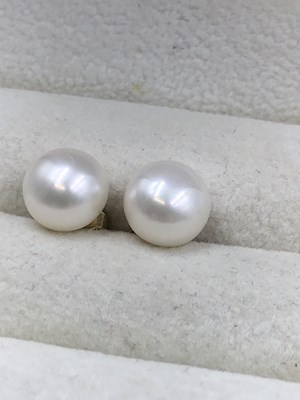 Lot 1046 - Pair of 9ct yellow gold studs set with white...