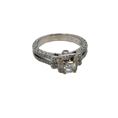 Lot 1044 - A 14ct white gold ring set with a central...