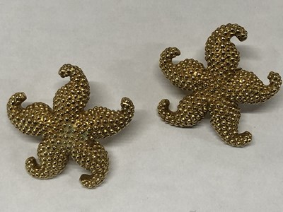 Lot 1089 - A pair of textured starfish design earrings...