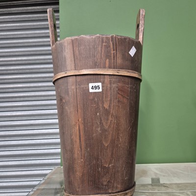 Lot 495 - A tall two handled wooden coopered bucket