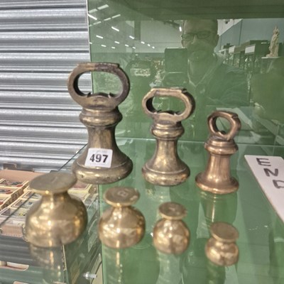 Lot 497 - A  set of three brass weights together with...