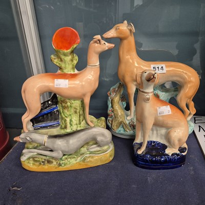 Lot 514 - Three Staffordshire pottery greyhound figurines