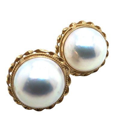 Lot 1101 - A pair of domed mabe pearl earrings with a...