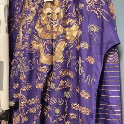 Lot 1238 - A Chinese blue ground silk four clawed dragon...