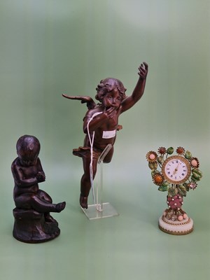 Lot 1248 - A copper rich figure of an amorini blowing a...