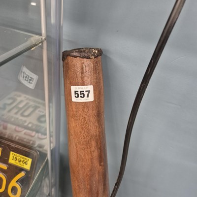 Lot 557 - An ethnic carved wood horn shaped wind instrument