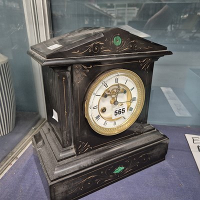 Lot 565 - A black slate cased striking mantle clock
