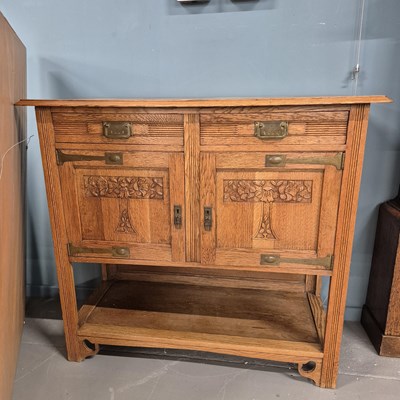 Lot 1 - An early 20th-century oak serving buffet...
