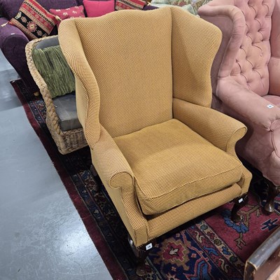 Lot 19 - A wing back armchair.