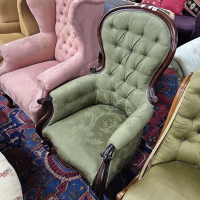 Lot 21 - A Victorian button back armchair.