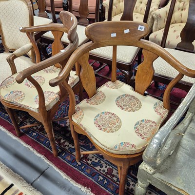 Lot 30 - A pair of oriental hardwood corner armchairs.