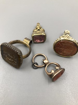 Lot 1112 - A group of four antique carved seal fobs.