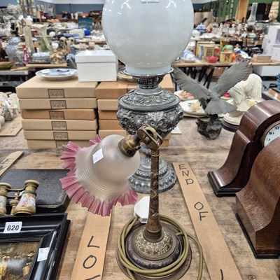 Lot 621 - An oil lamp together with an adjustable table...