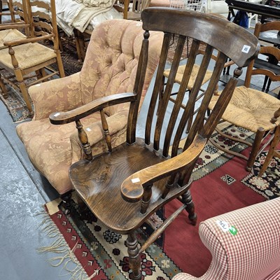 Lot 45 - An antique country slat back armchair