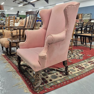 Lot 46 - An antique, wing back armchair.