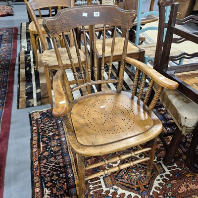 Lot 53 - An early 20th century spindle back armchair.