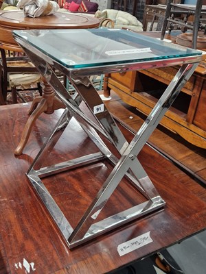 Lot 91 - A chrome and glass occasional table