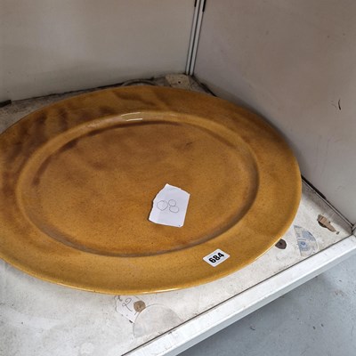 Lot 684 - An ochre glazed studio pottery dish
