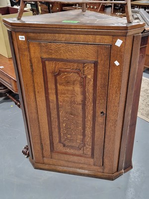 Lot 105 - A Georgian oak corner cabinet