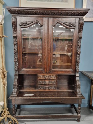 Lot 149 - An antique glazed oak bookcase on an...