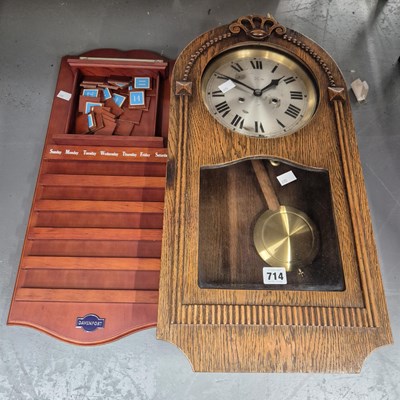 Lot 714 - A wall clock in a glazed oak case together...