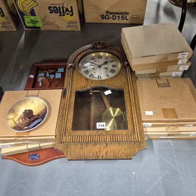 Lot 714 - A wall clock in a glazed oak case, together...