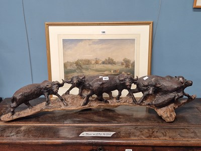 Lot 181 - A procession of buffalo. carved from a single...