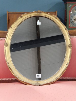 Lot 187 - A vintage oval gilt-framed wall mirror.