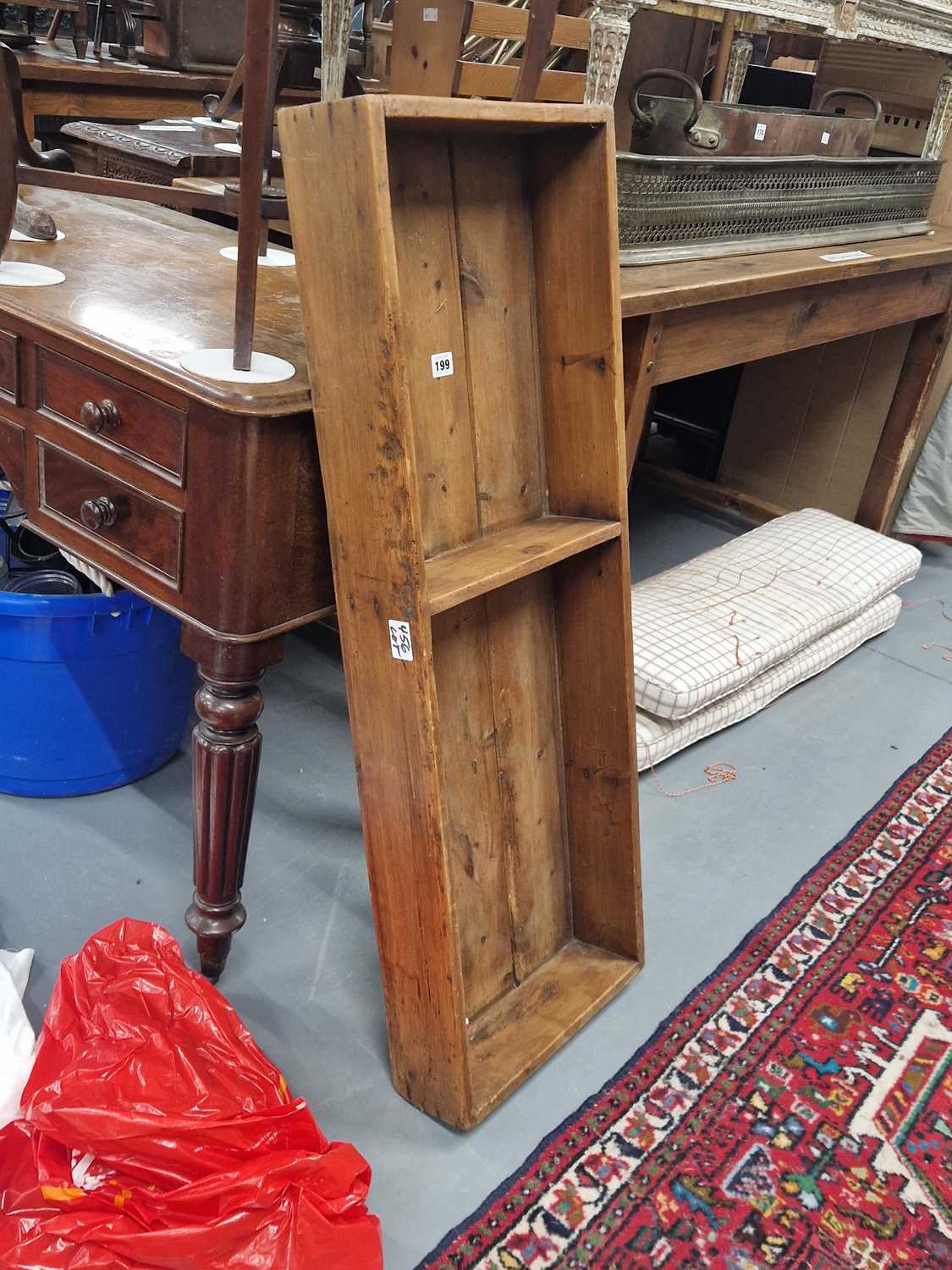 Lot 199 - A rustic pine wall shelf