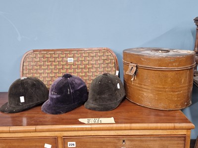 Lot 225 - Three riding hats (ornamental only), a tin hat...