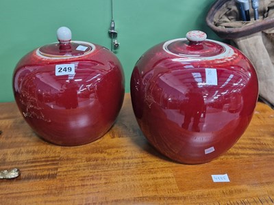 Lot 249 - A pair of oriental sang de boeuf ginger jars