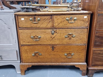 Lot 373 - A Georgian oak chest of two short and two long...